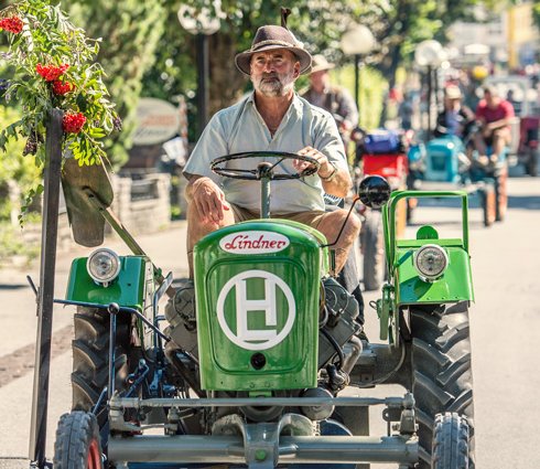 Mann mit Vollbart auf altem Oldtimer Traktor